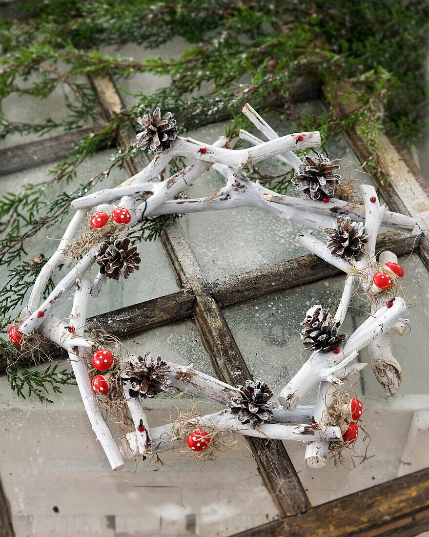 DIY wreath from small branches and pine cones for Christmas