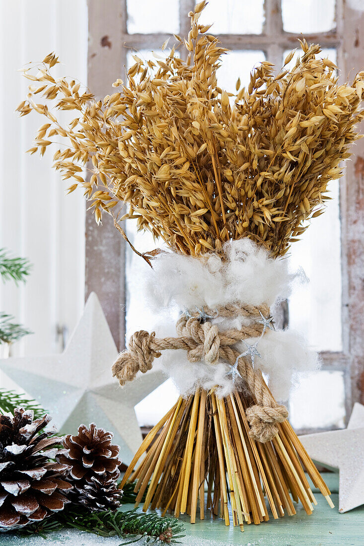 Dried oat ears wrapped in wool as Christmas decorations