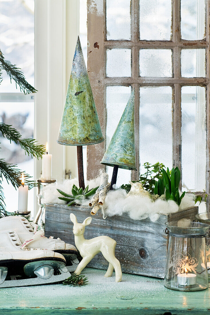 DIY winter landscape made of soft wool, plants, and Christmas trees made out of tin cones