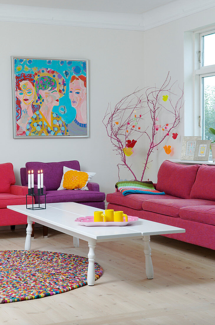 Pink and purple Upholstered furniture in a colorful living room