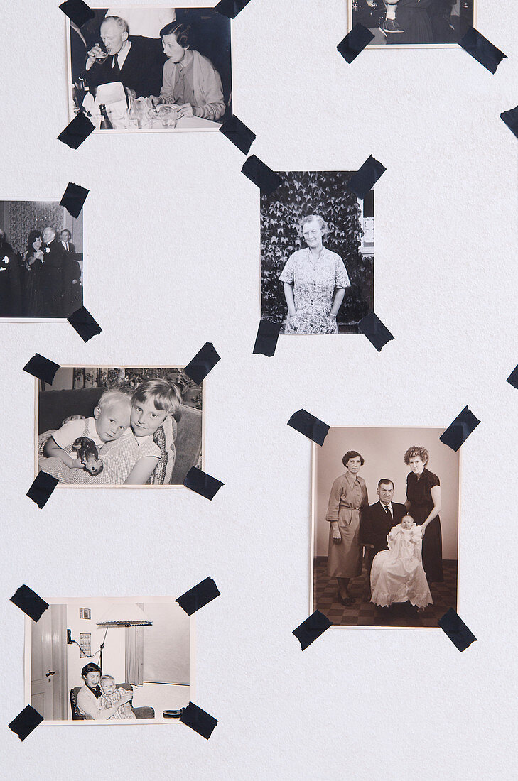 Black and white photos with black masking tape on the wall