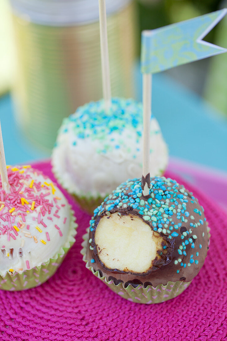 Cake pops decorated with sprinkles and paper flags