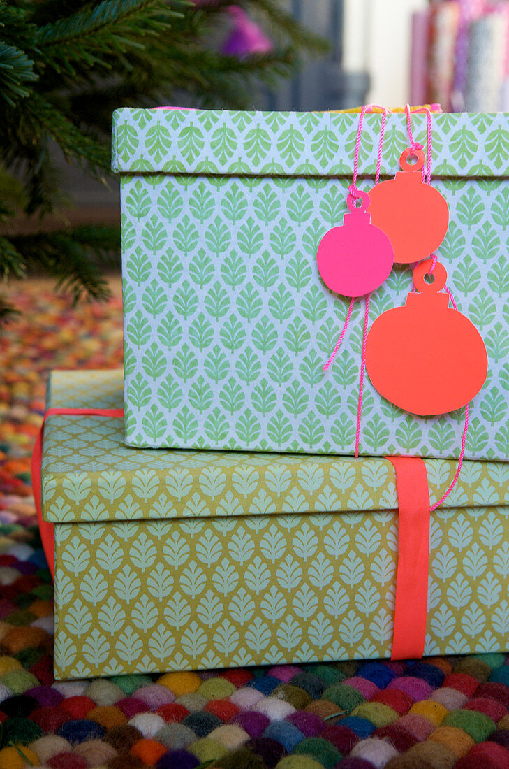 Homemade gift tags in the shape of a Christmas tree ornament made of paper