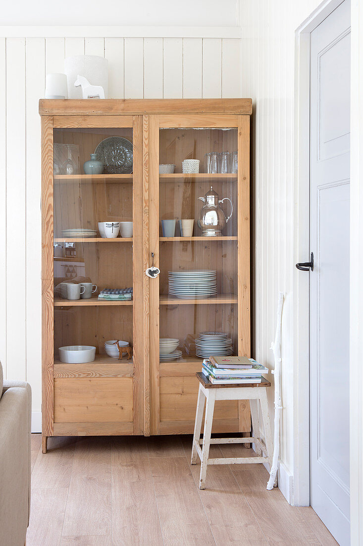 Crockery in a country style wooden display cabinet
