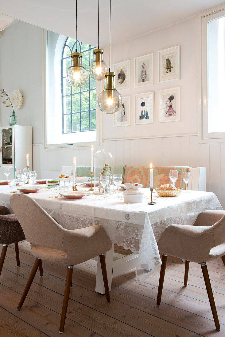 Festively set table with upholstered retro chairs