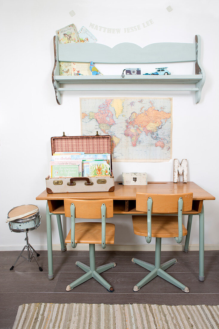 Old chairs at school desk and vintage-style accessories in child's bedroom