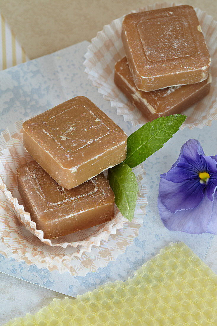 Honey soap in muffin liners with verbena leaves and pansies