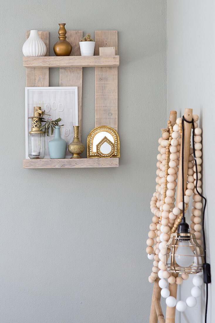 Rustic small wall shelf made of reclaimed wood with boho-style decoration
