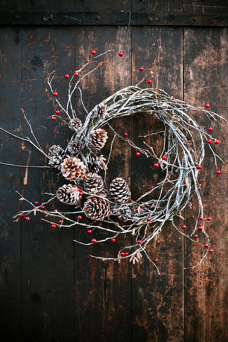 Winter wreath made from berry twigs and cones
