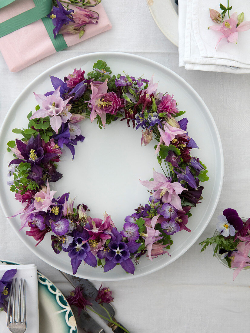Wreath of different columbines in pink, violet, and lilac