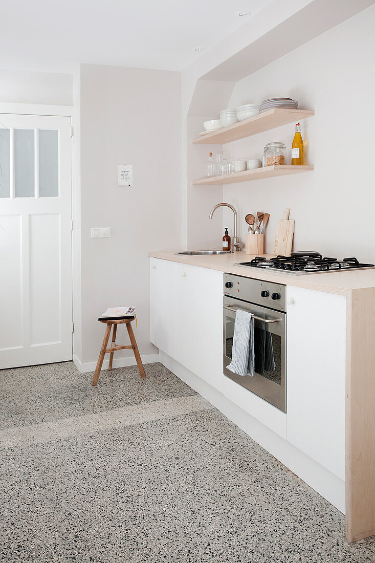 White kitchenette and terrazzo floor