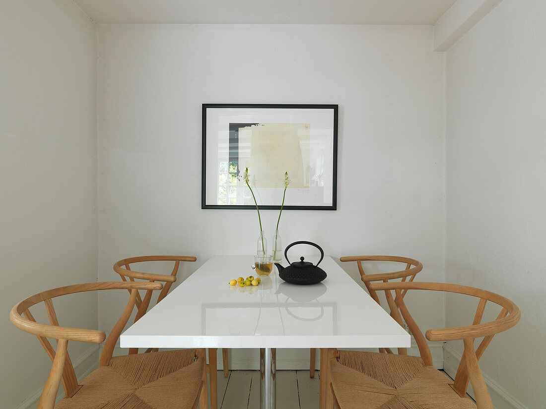 Designer chairs at a white table in a small dining room