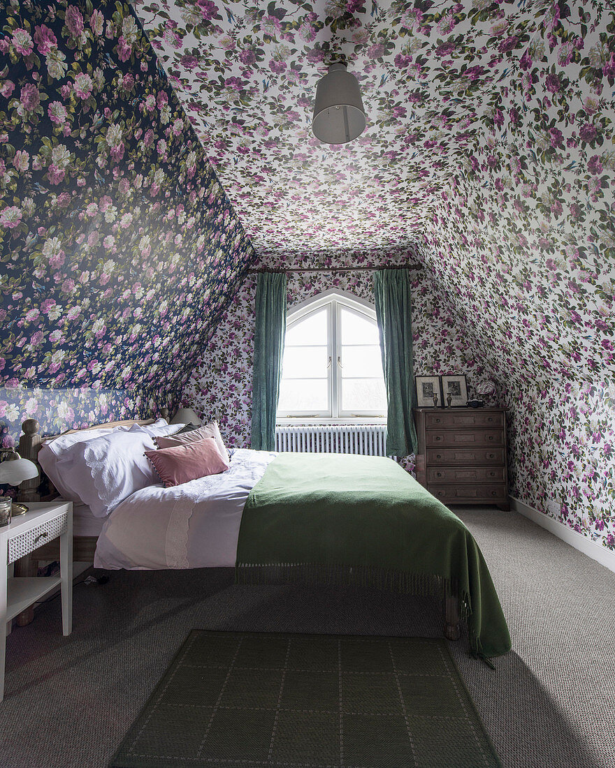 Floral wallpaper in attic bedroom with sloping walls