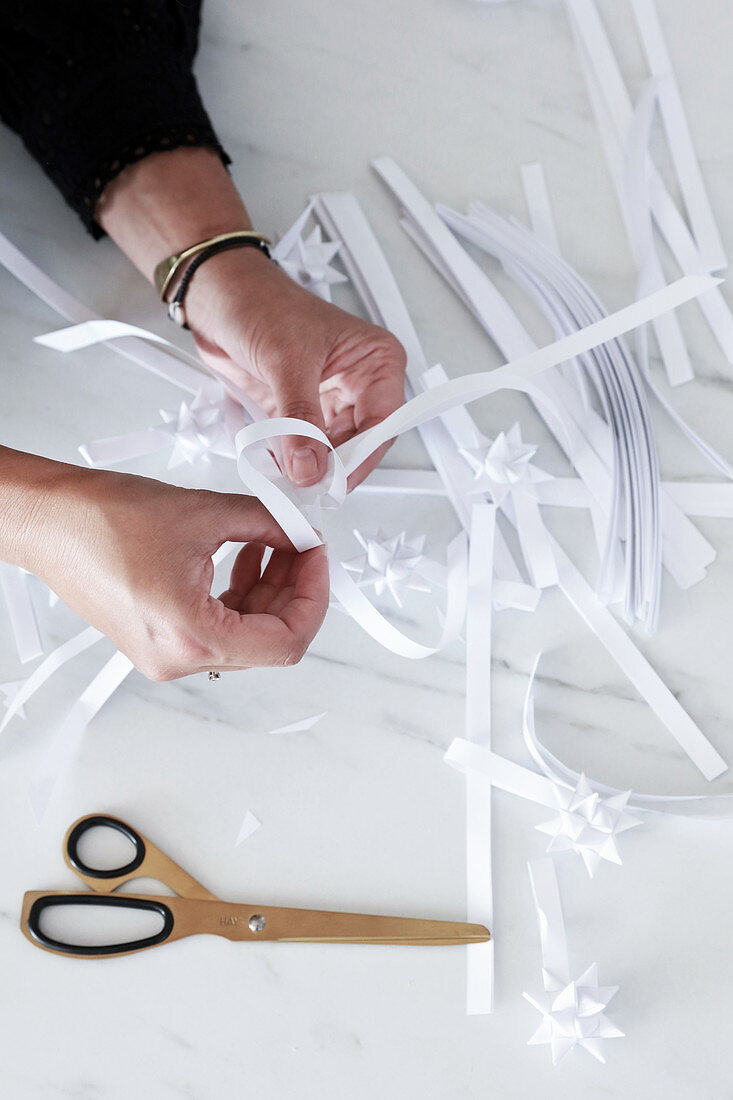 Folding paper strips into Christmas stars