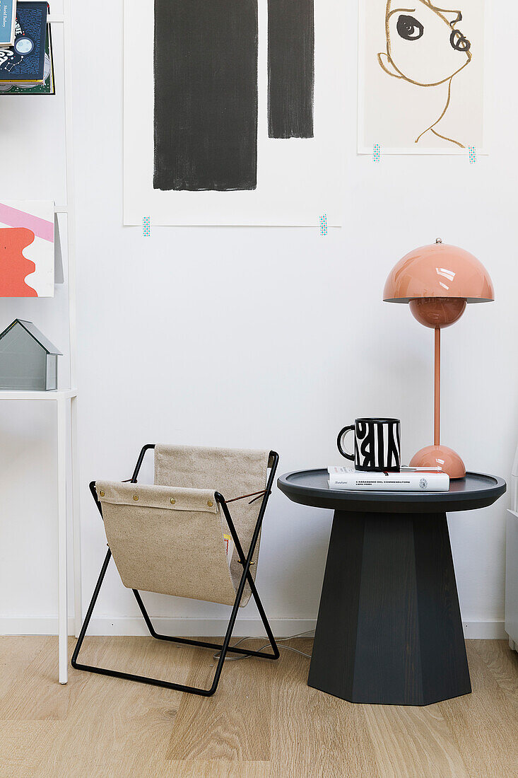 Pink designer lamp on side table and magazine rack