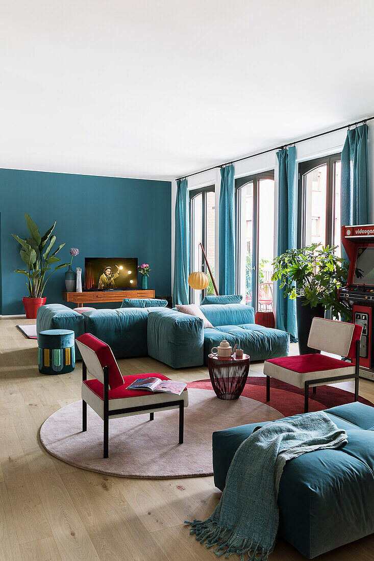 Blue and red upholstered furniture in mid-century-style living room