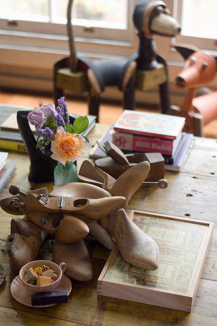 Shoe lasts and vintage accessories on old wooden table