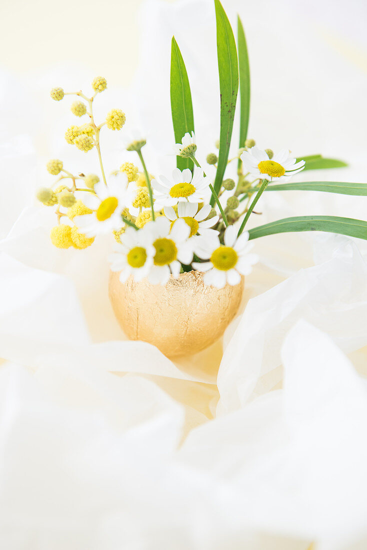 Flowers in vase made from gilded egg shell