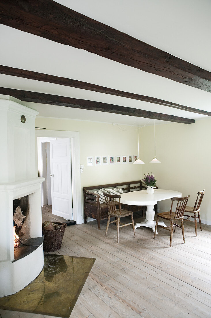 Open fireplace and wood-beamed ceiling in country-house-style dining room