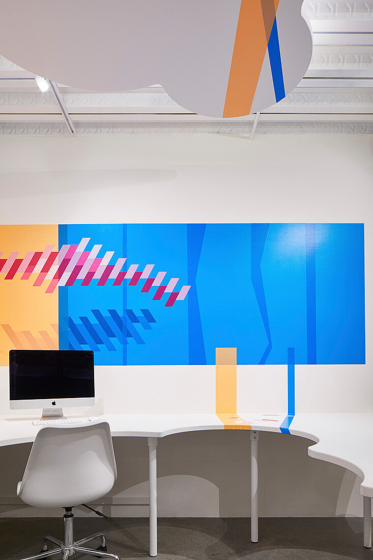 Graphic design on desk and wall in office with cloud-shaped suspended ceiling at HARU Gallery, London, United Kingdom