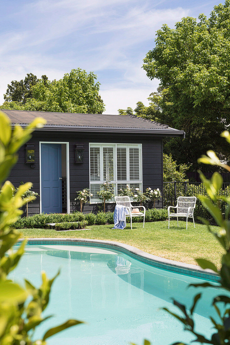 Pool and wooden house in the garden