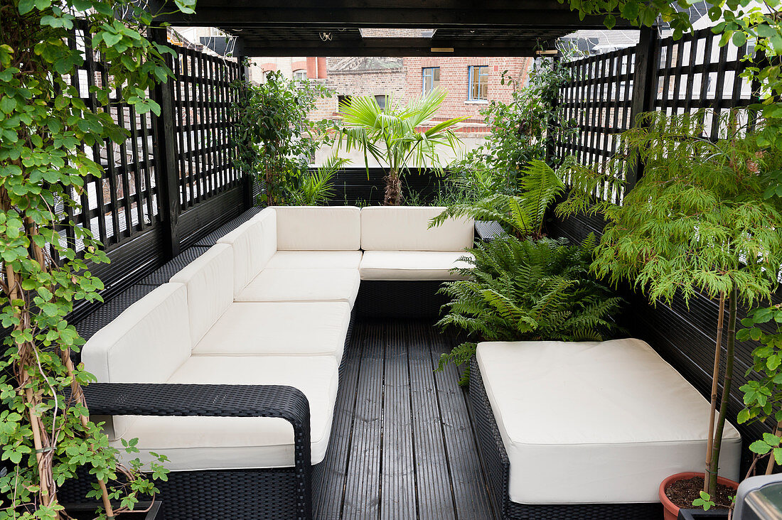 Spacious, modern outdoor sofa on roof terrace