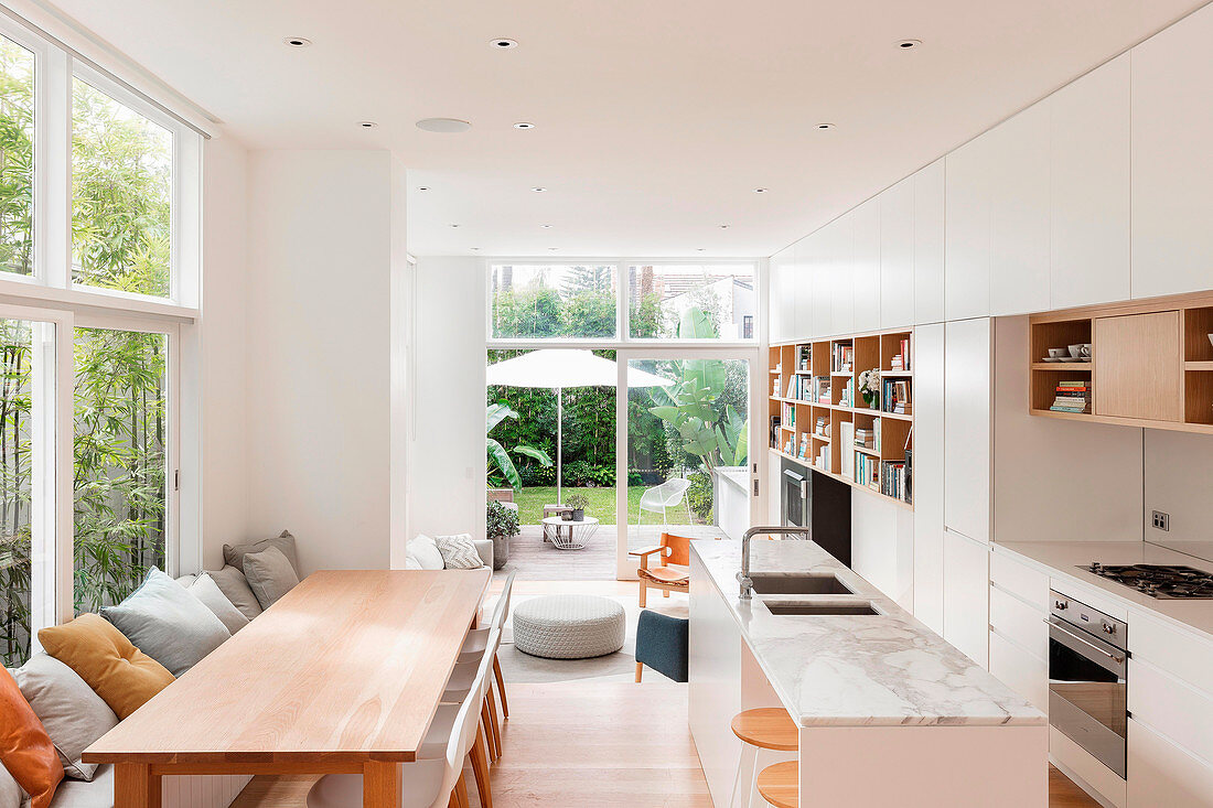 White kitchen with dining area in open living room
