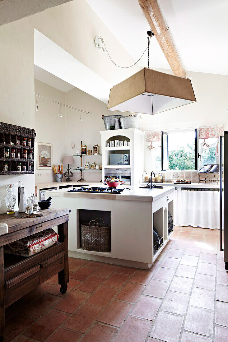 Country house kitchen with kitchen island and terracotta tiles