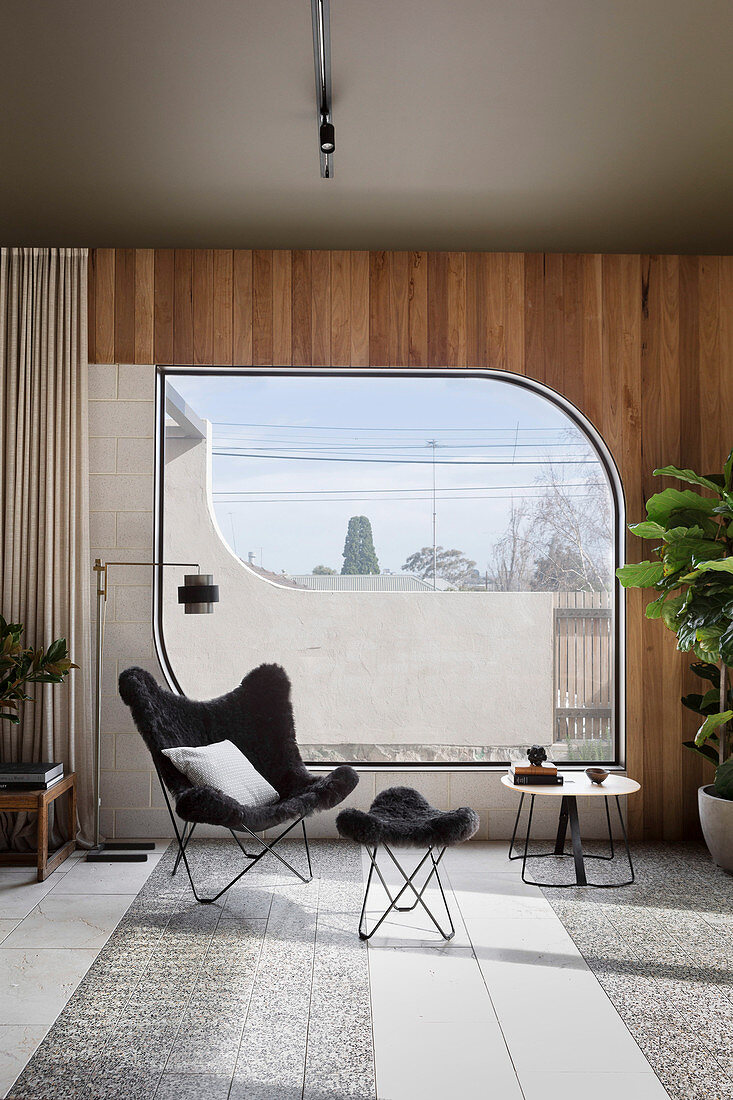 Classic chair with ottoman in front of window