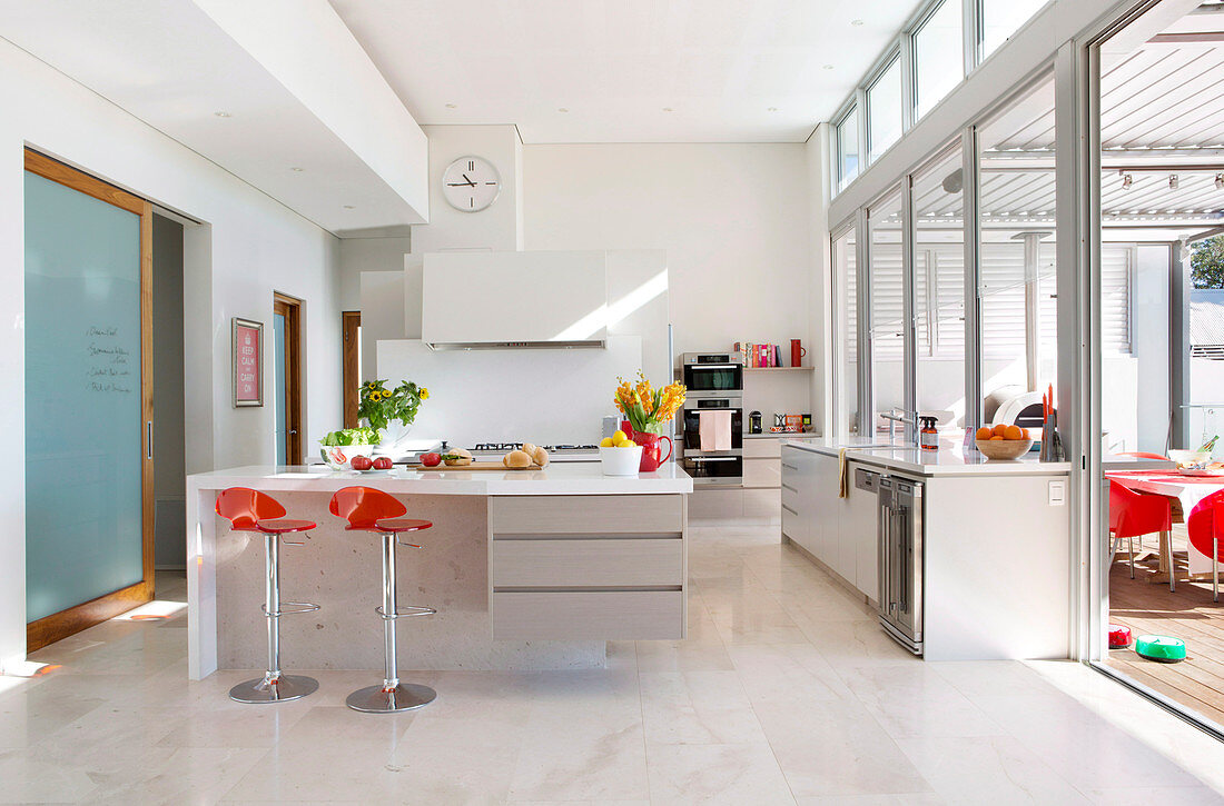 Modern open kitchen with window front to the terrace
