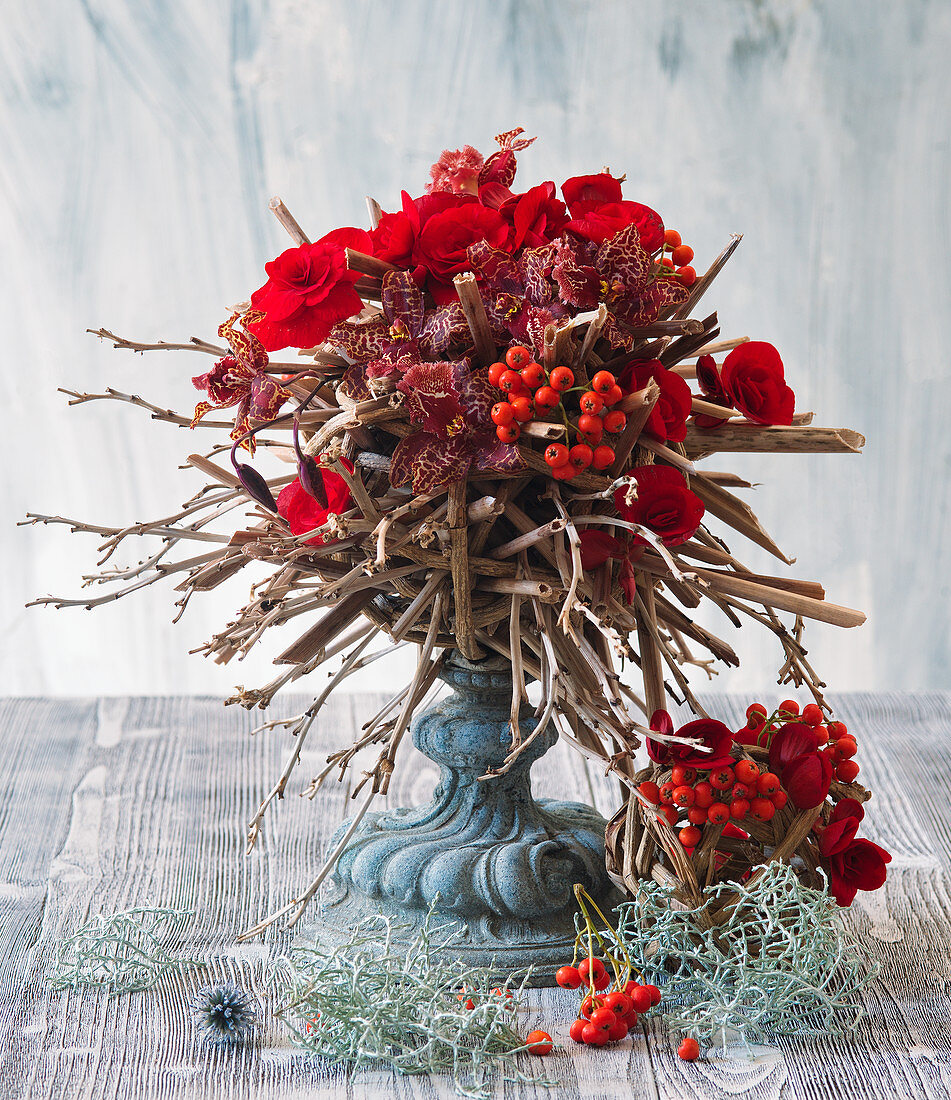 Bouquet of red begonias, orchids and rowan berries