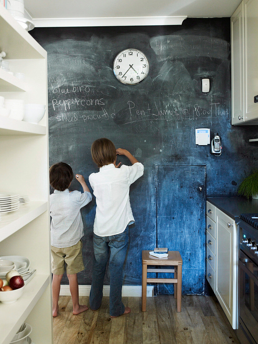 Boys in front of chalk wall in the kitchen