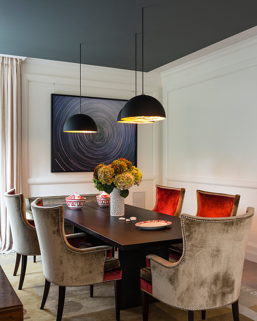 Velvet chairs and panelled walls in luxurious dining room