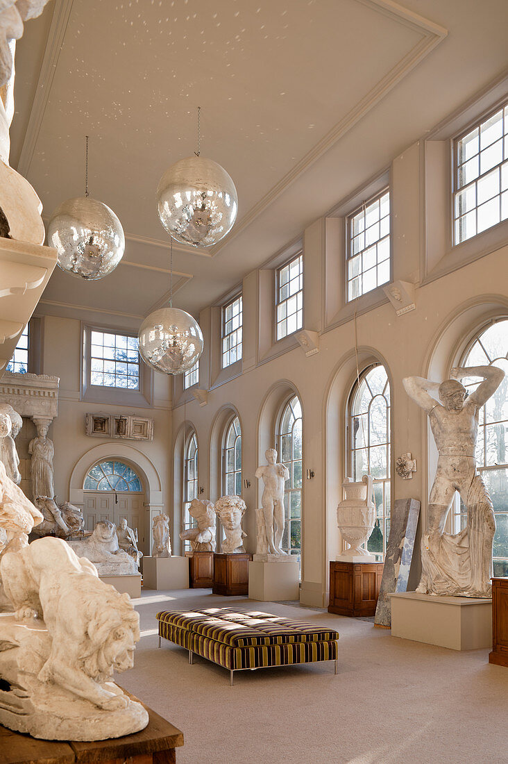 A collection of large plaster casts in the orangery with disco balls