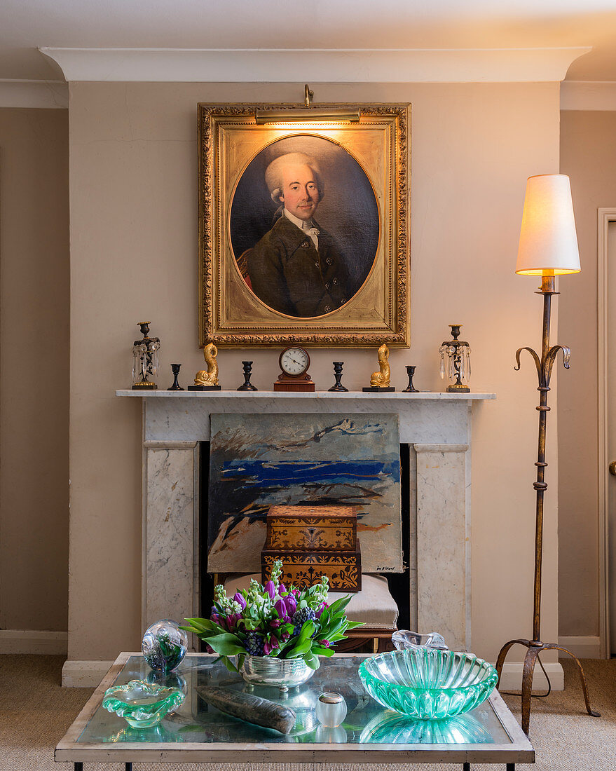 Antique portrait in gilt frame above fireplace in living room