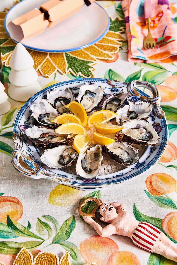 Oysters with lemons on a colorful Christmas table