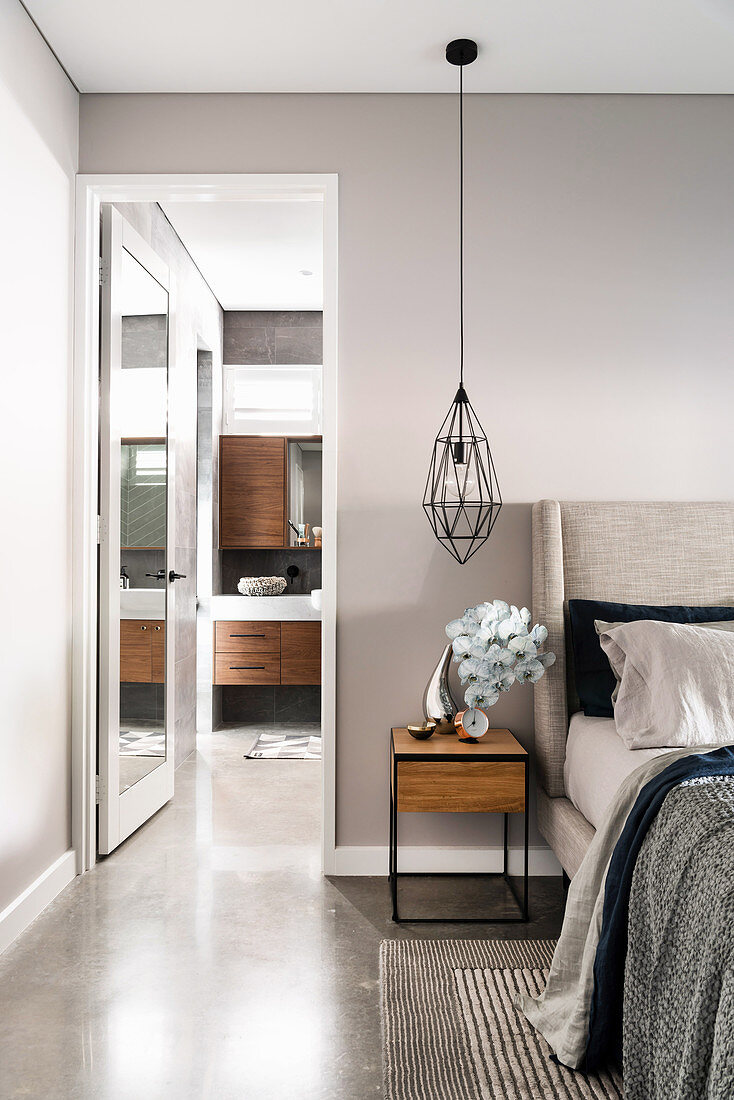 Modernes Schlafzimmer in Grau mit Blick ins Bad