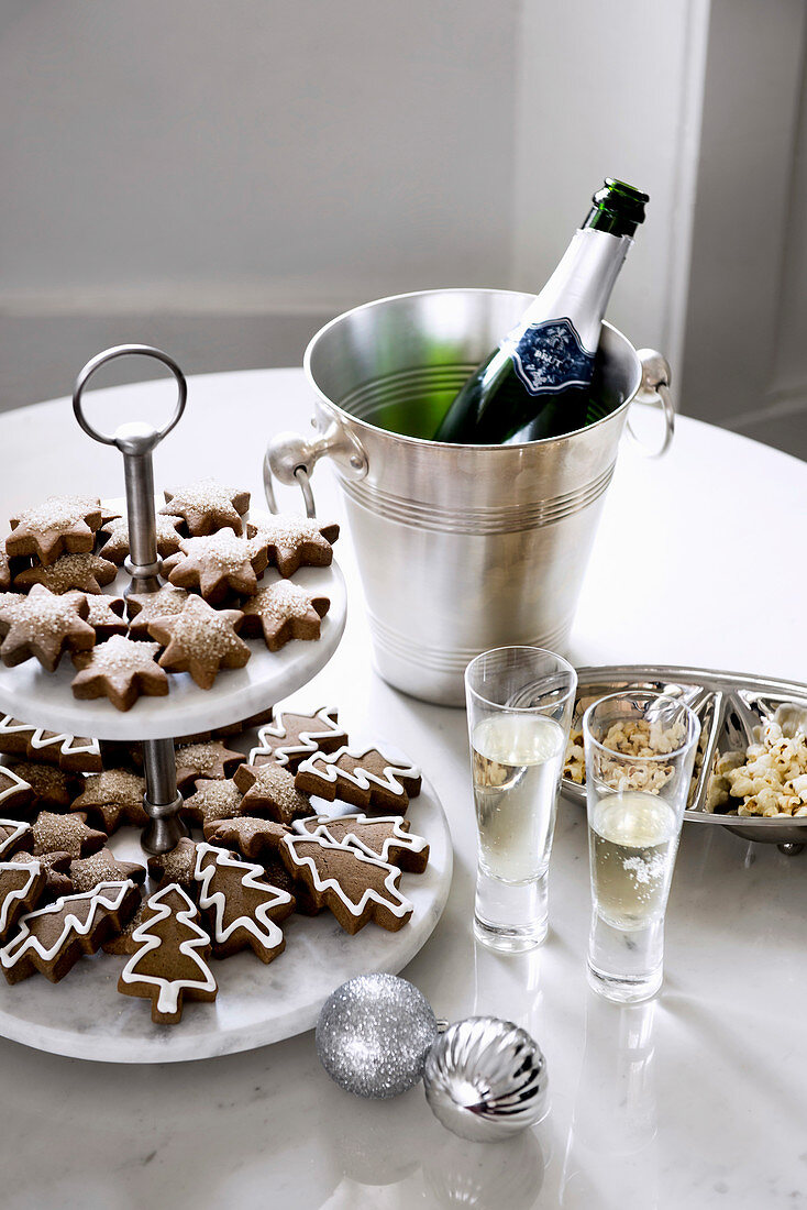 Christmas cookies on a cake stand and sparkling wine