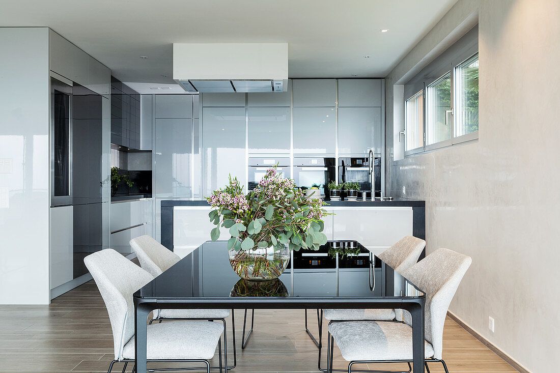 Modern dining table in minimalist kitchen-dining room in grey and beige
