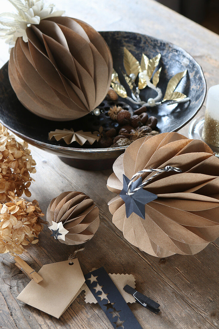 Original arrangement of honeycomb balls handcrafted from brown paper on rustic wooden table