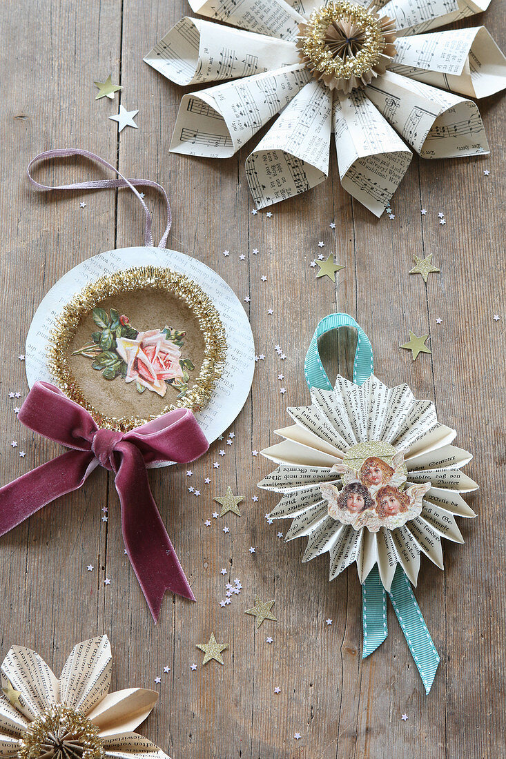 Christmas decorations handcrafted from book pages, scrapbook pictures of rose and angel, ribbons and glitter