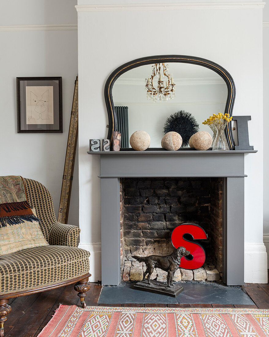Red letter S in disused open fireplace in classic living room