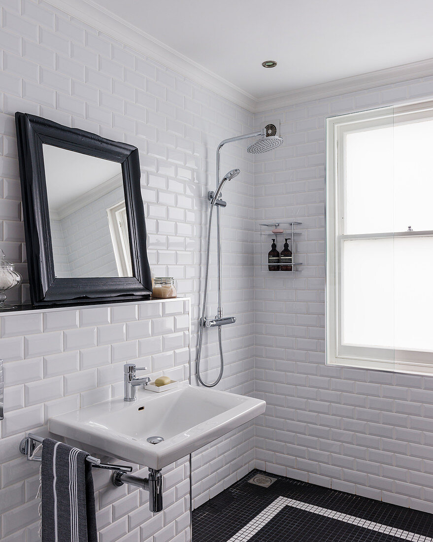 Classic black-and-white bathroom with subway wall tiles and mosaic floor