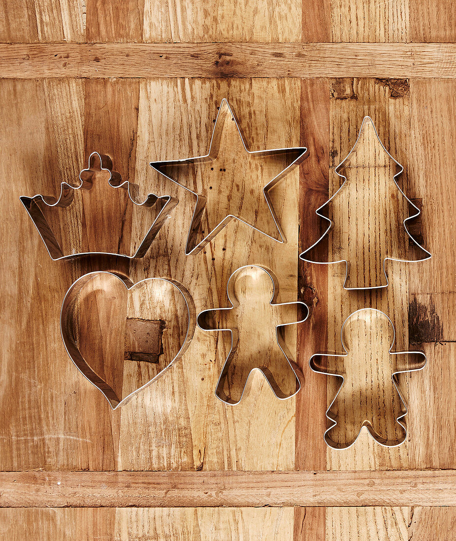 Festive pastry cutters on wooden surface