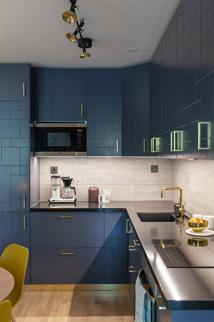 Modern, fitted kitchen with blue, structured cabinets