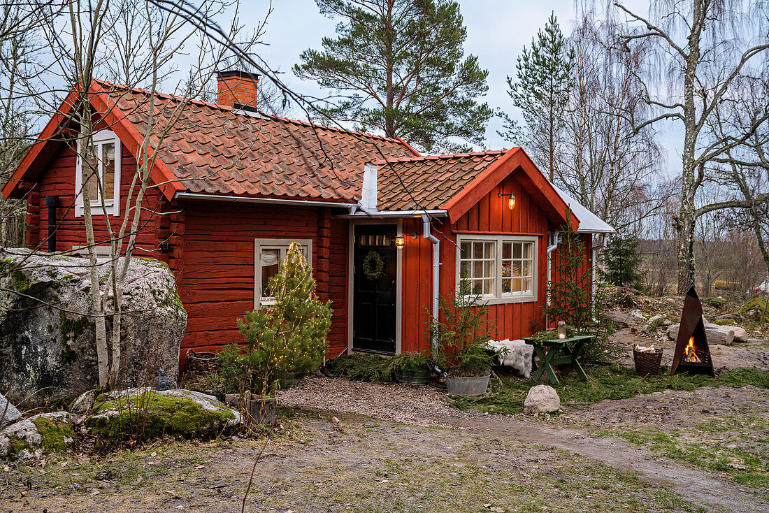 Rustic red Swedish house rocky landscape
