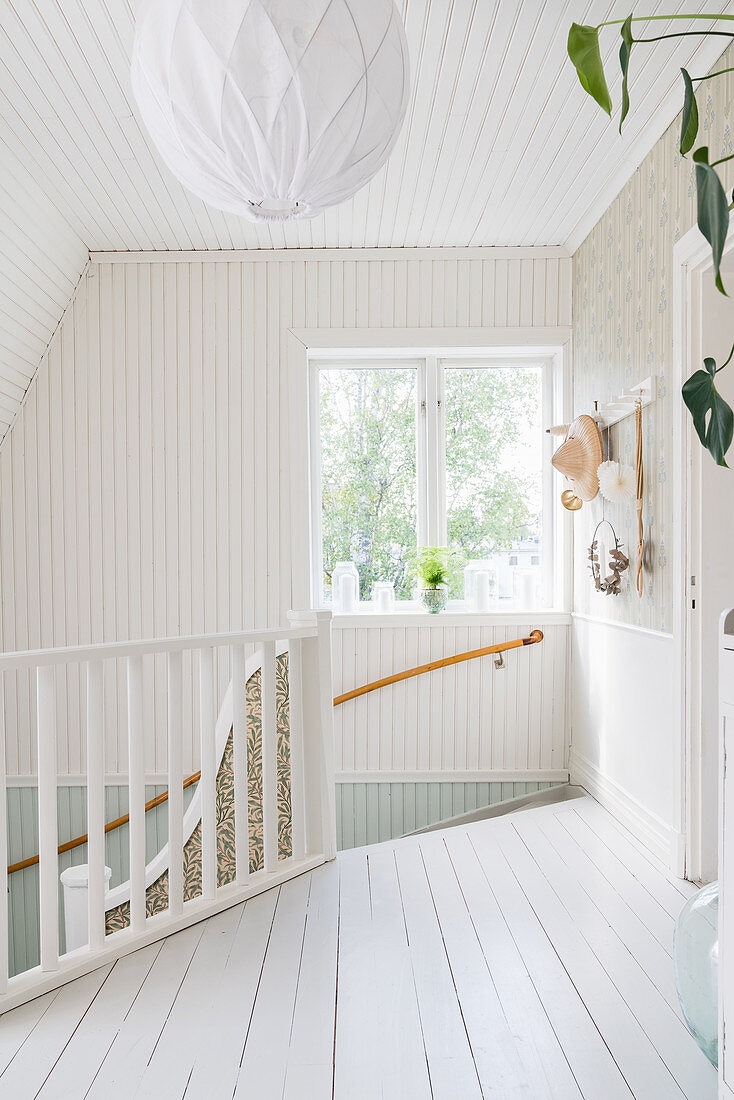 Bright, Scandinavian-style stairwell and landing with board floor