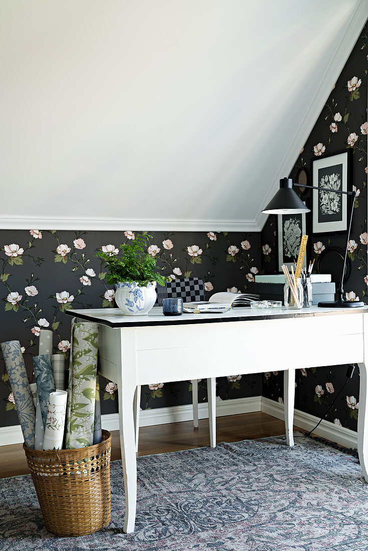 Black rose-patterned wallpaper in study