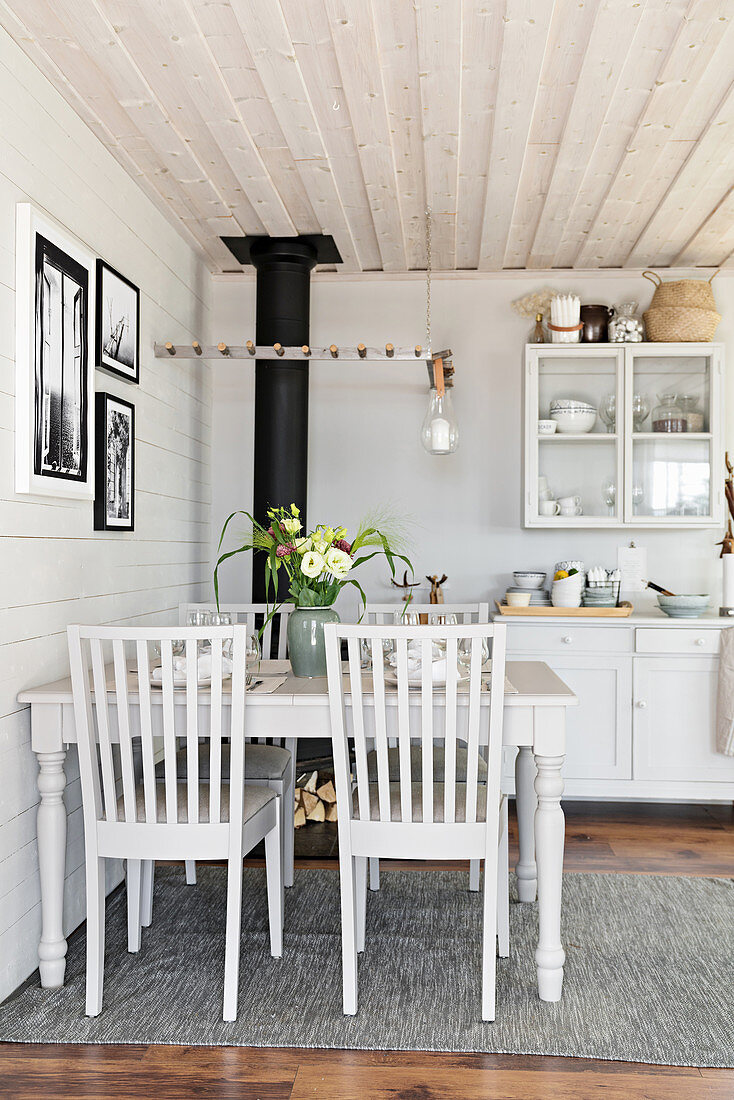 Dining table in rustic kitchen-dining room in shades of grey