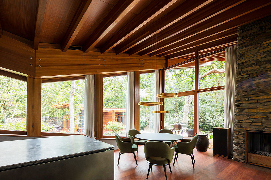 Dining room with glass wall in sustainable, architect-designed house